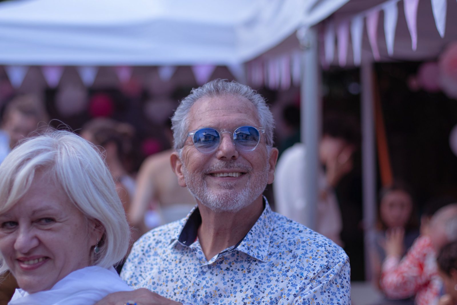Deux invités souriants sous le chapiteau